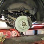 Car brake rotor and suspension on lift