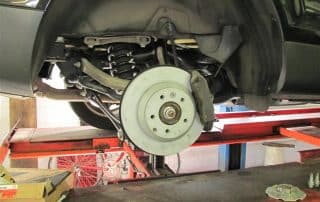 Car brake rotor and suspension on lift