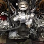 Close-up of car engine with exposed timing components