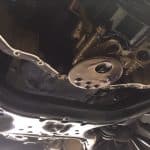 Underside of car engine with oil pan removed