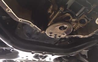 Underside of car engine with oil pan removed