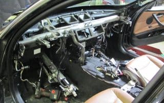 Car interior with dashboard removed and exposed wiring