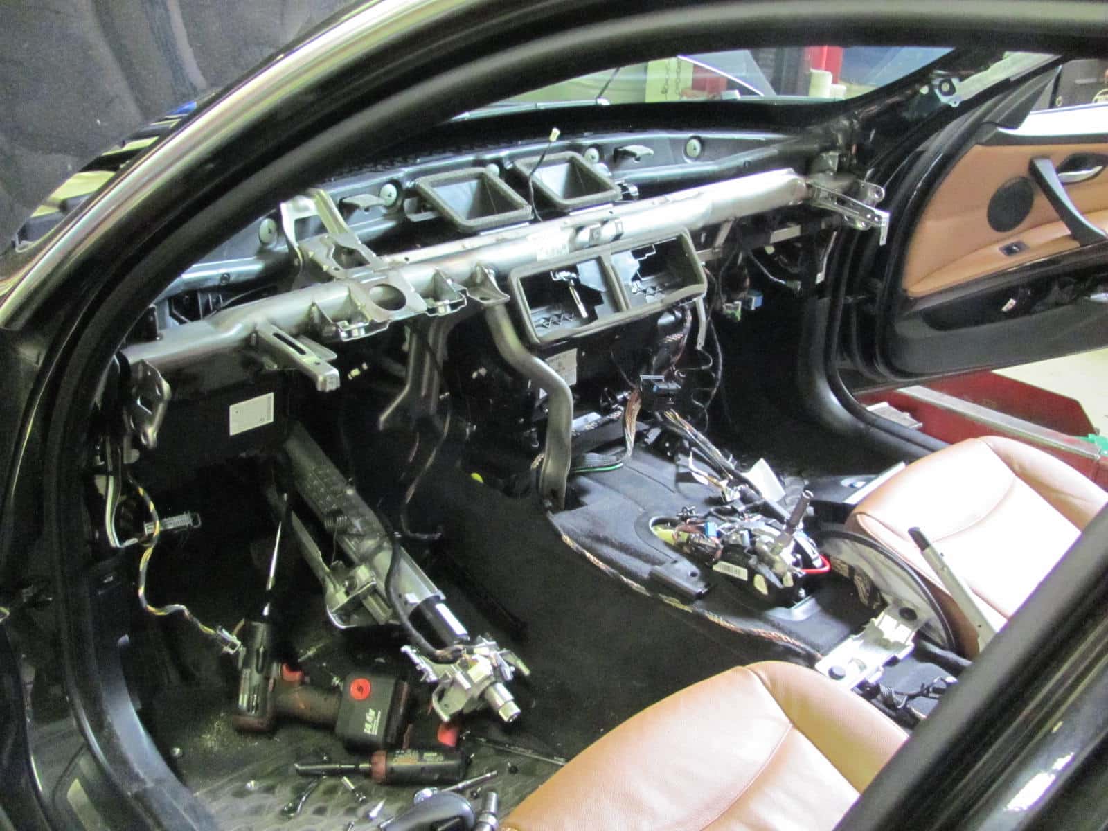 Car interior with dashboard removed and exposed wiring