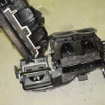 Disassembled car HVAC unit on workshop floor