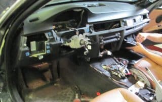 Car interior with dashboard removed for repair
