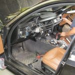 Mechanic repairing car dashboard inside vehicle