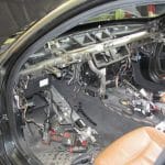 Car interior with dashboard removed and exposed wiring