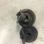 Two metal pump impellers on workbench