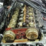 Exposed car engine with visible camshafts and timing chain