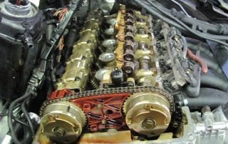 Exposed car engine with visible camshafts and timing chain
