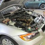 Car with hood open in repair shop