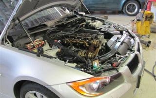 Car with hood open in repair shop