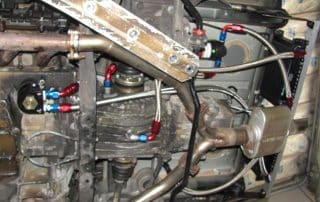 Car undercarriage with exhaust and fuel lines