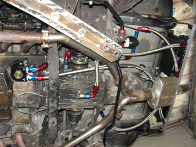 Car undercarriage with exhaust and fuel lines