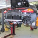 Sports car lifted in auto repair shop