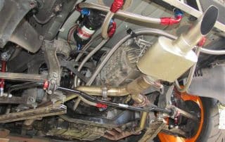Car undercarriage with exhaust and suspension components