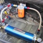 Aftermarket fuel system components installed in car trunk