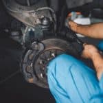 Mechanic repairing car brake rotor assembly