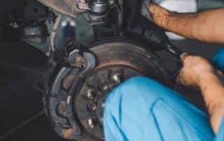 Mechanic repairing car brake rotor assembly