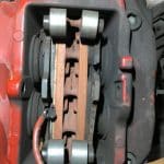 Close-up of car brake caliper and pads