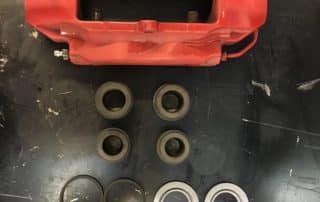 Red brake caliper with seals and components