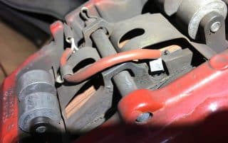 Close-up of car brake caliper and pads