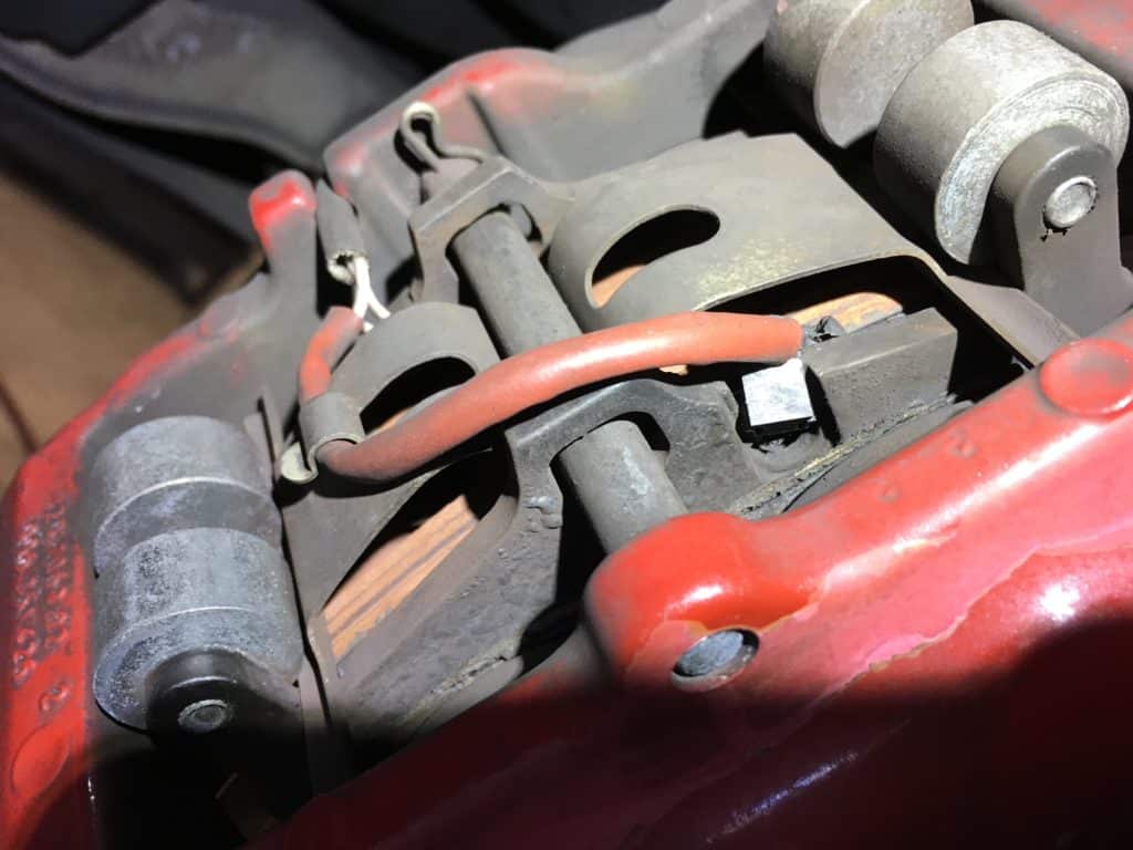 Close-up of car brake caliper and pads