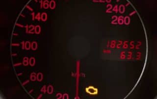 Car speedometer with warning lights illuminated
