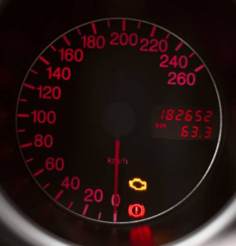 Car speedometer with warning lights illuminated
