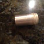 Small metal cylinder on granite countertop