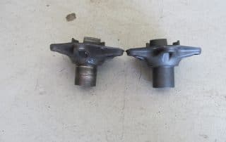 Worn and new metal automotive parts side by side