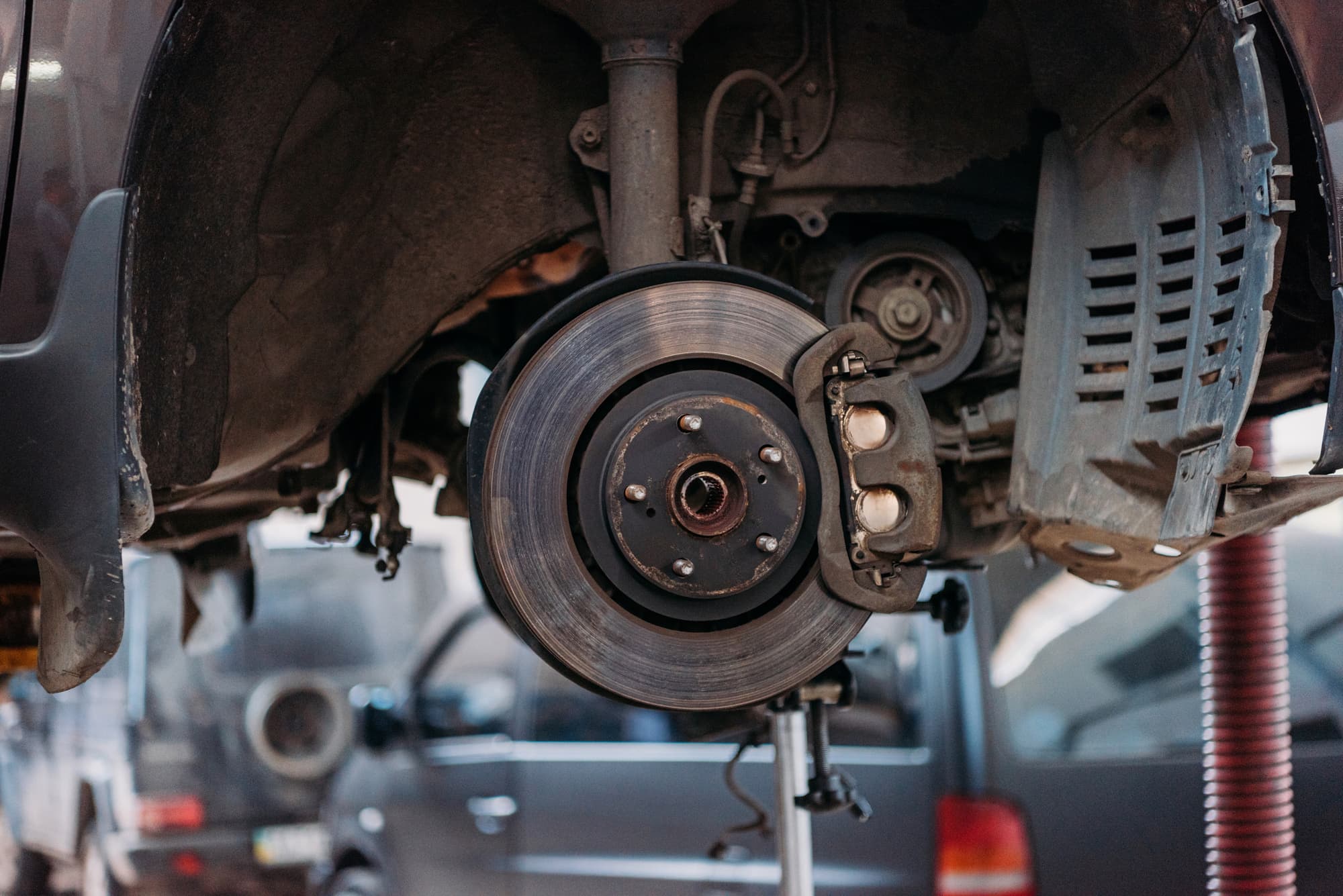 Car brake rotor and caliper on lift