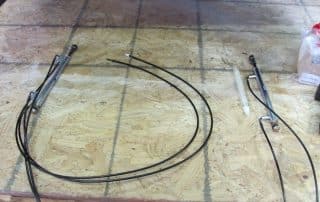 Mechanical cables and metal rods on workbench