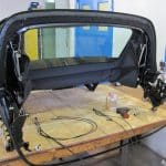 Convertible car top frame on workshop bench