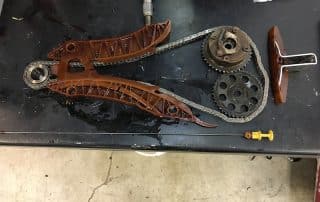 Engine timing chain and components on workbench