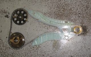 Engine timing chain and sprockets on floor