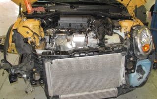 Car with front bumper removed exposing engine