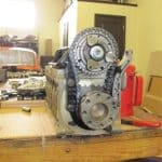 Engine block with exposed timing gears on workbench