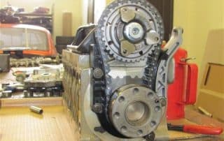 Engine block with exposed timing gears on workbench