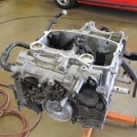 Car engine block on stand in garage