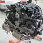 Car engine removed and mounted in garage