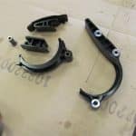 Black automotive chain guides on cardboard surface