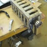 Engine cylinder head on workshop bench