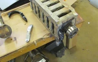 Engine cylinder head on workshop bench