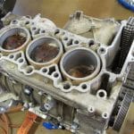 Car engine block with visible pistons