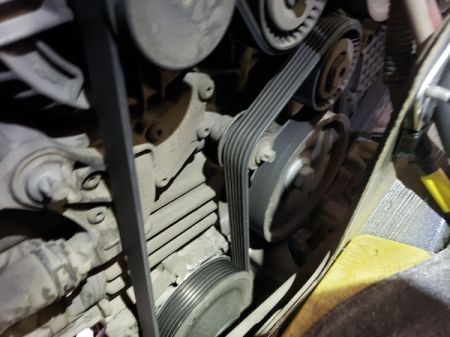 Close-up of car engine serpentine belt and pulleys