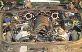 Car engine bay with exposed intake manifold