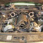 Car engine bay with exposed intake manifold