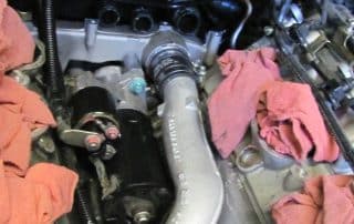 Close-up of car engine with pink rags