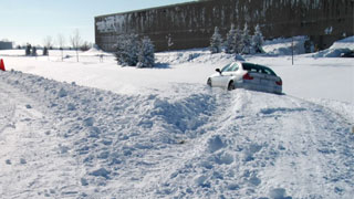 Car stuck in deep snow near building